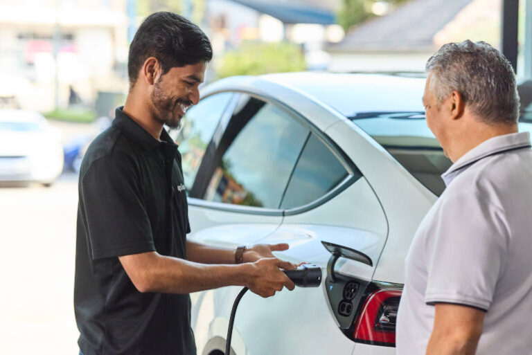 A driver charging their electric car